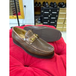 Perforated brown leather shoe